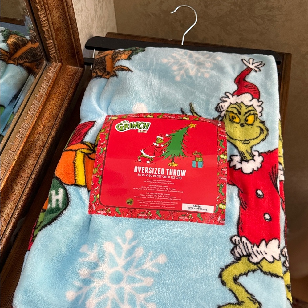 The Grinch Dr Seuss oversized throw.  50” x 60”. 100% Polyester.